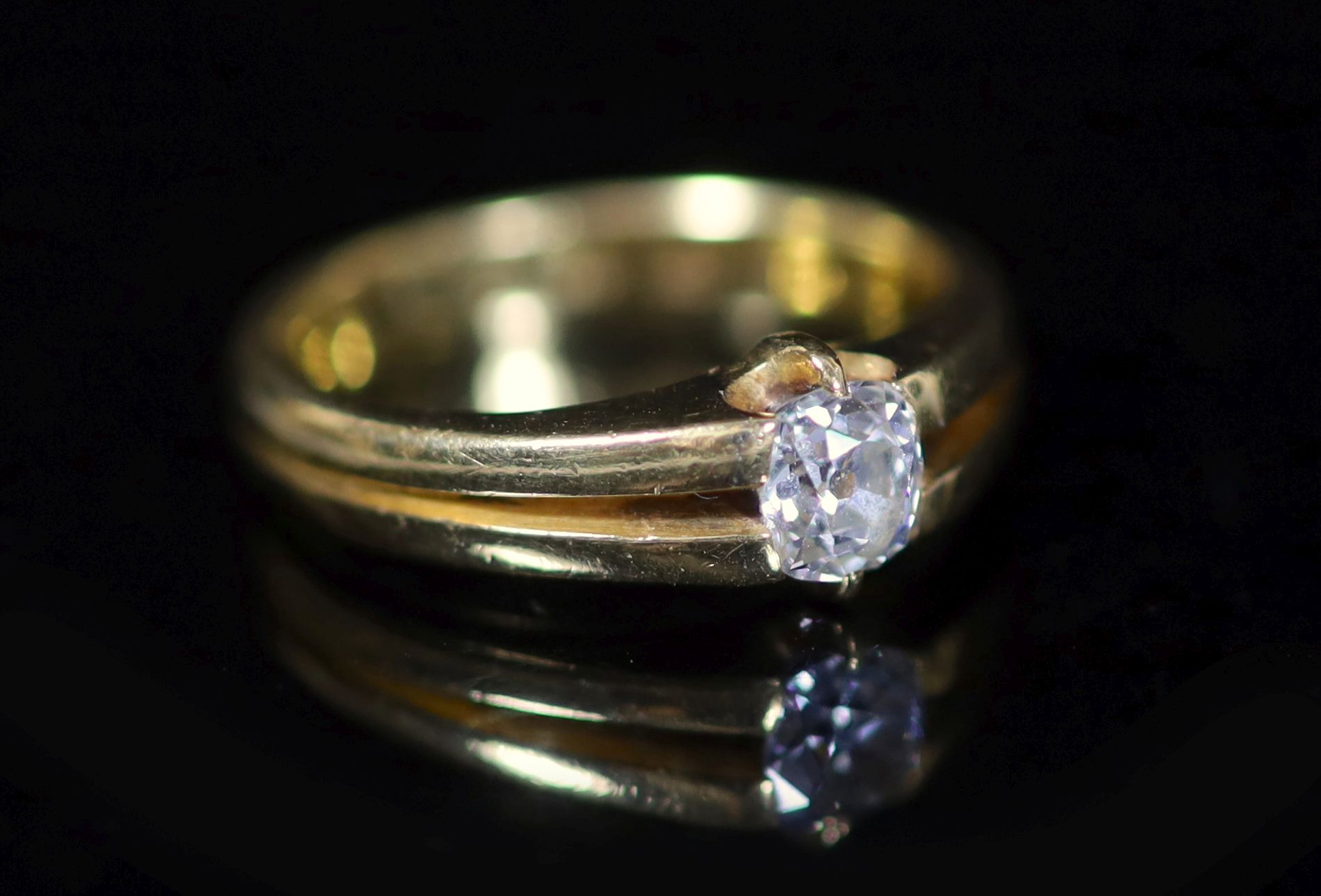 A late Victorian 22ct yellow gold diamond solitaire ring, the claw-set oval cut diamond approximately 0.5ct